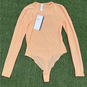 Lululemon Wundermost Nulu Mesh Long-Sleeve Crewneck Bodysuit in Peach Bellini